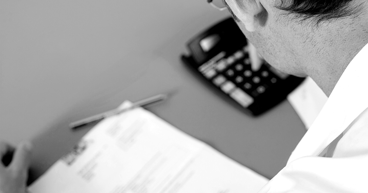 man using a calculator working out redundancy package